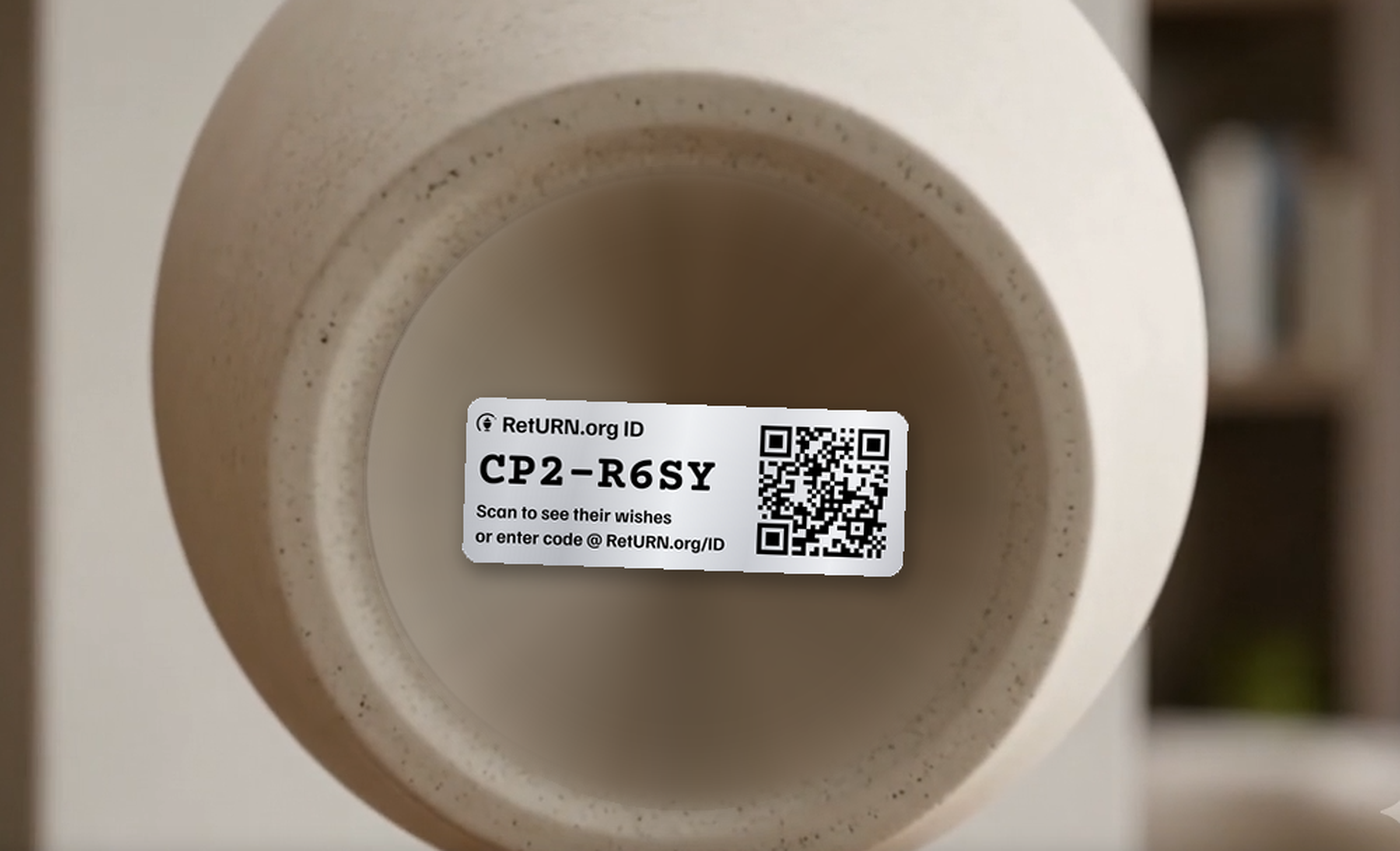 The base of a ceramic urn with a RetURN.org ID label applied to it, showing the code CP2-R6SY and its QR code.